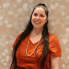 April smiling in an orange top