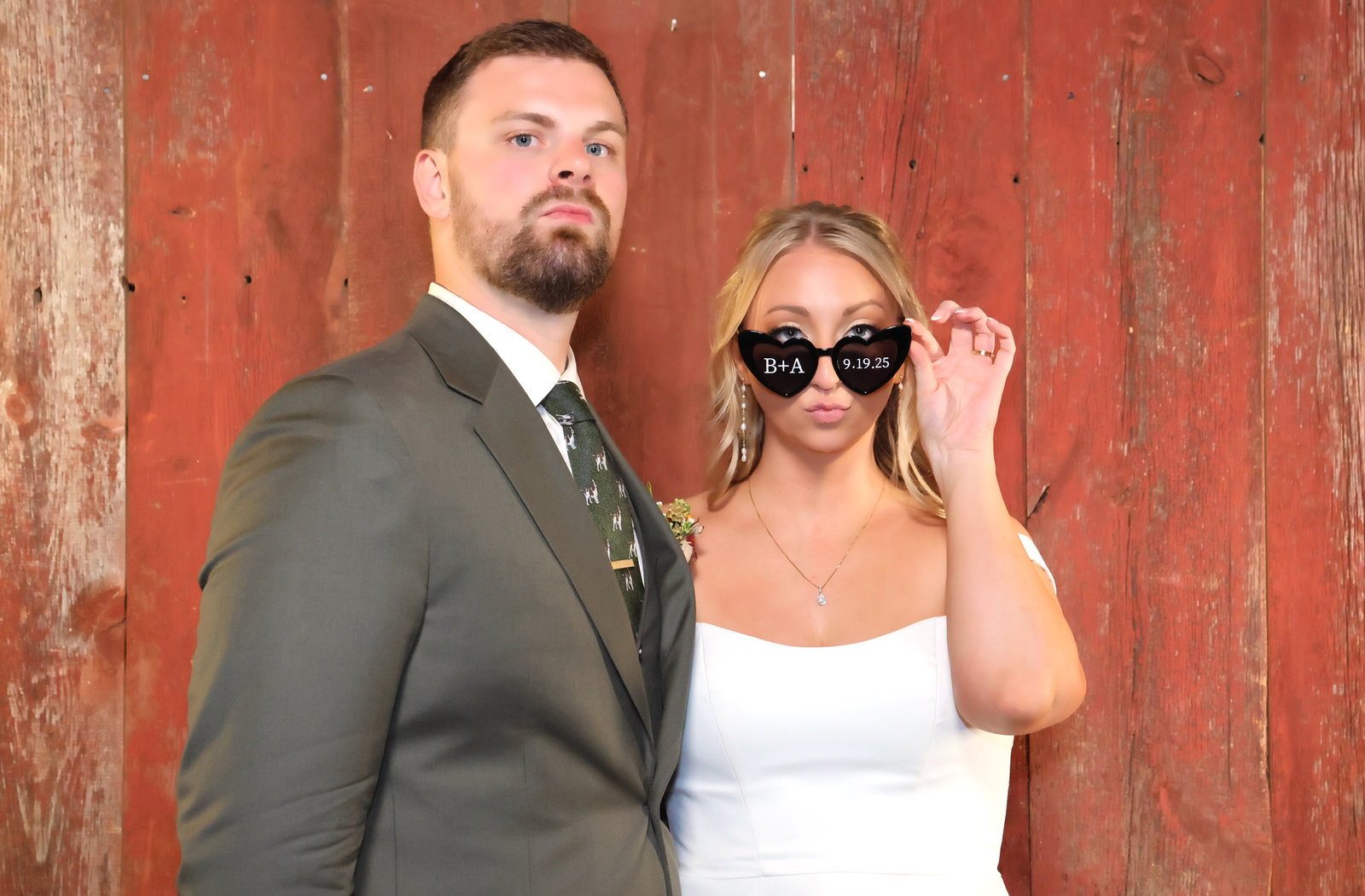 Couple in a full color Gala portrait against a red barn-wood backdrop