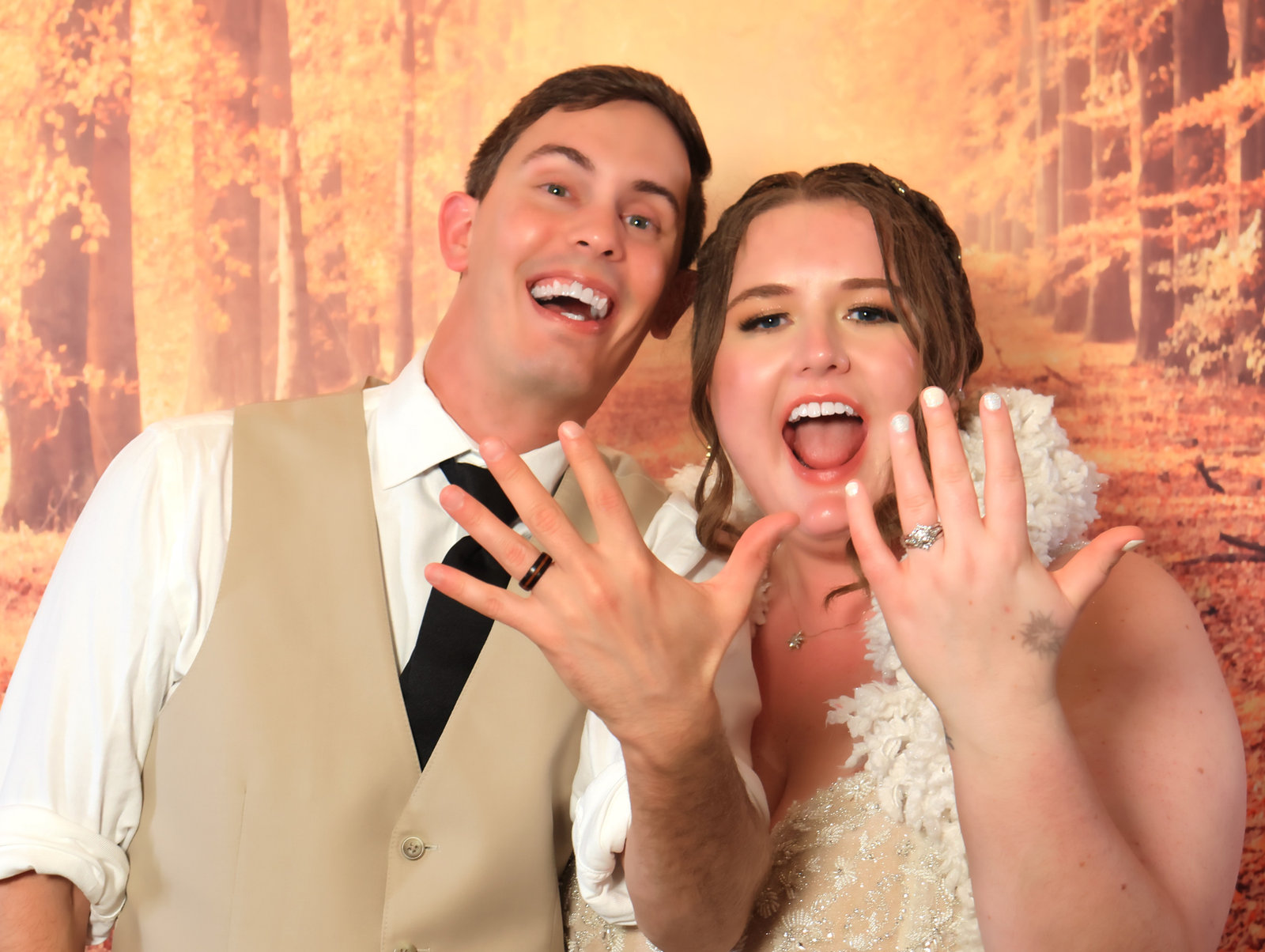 Bride and groom showing off their rings