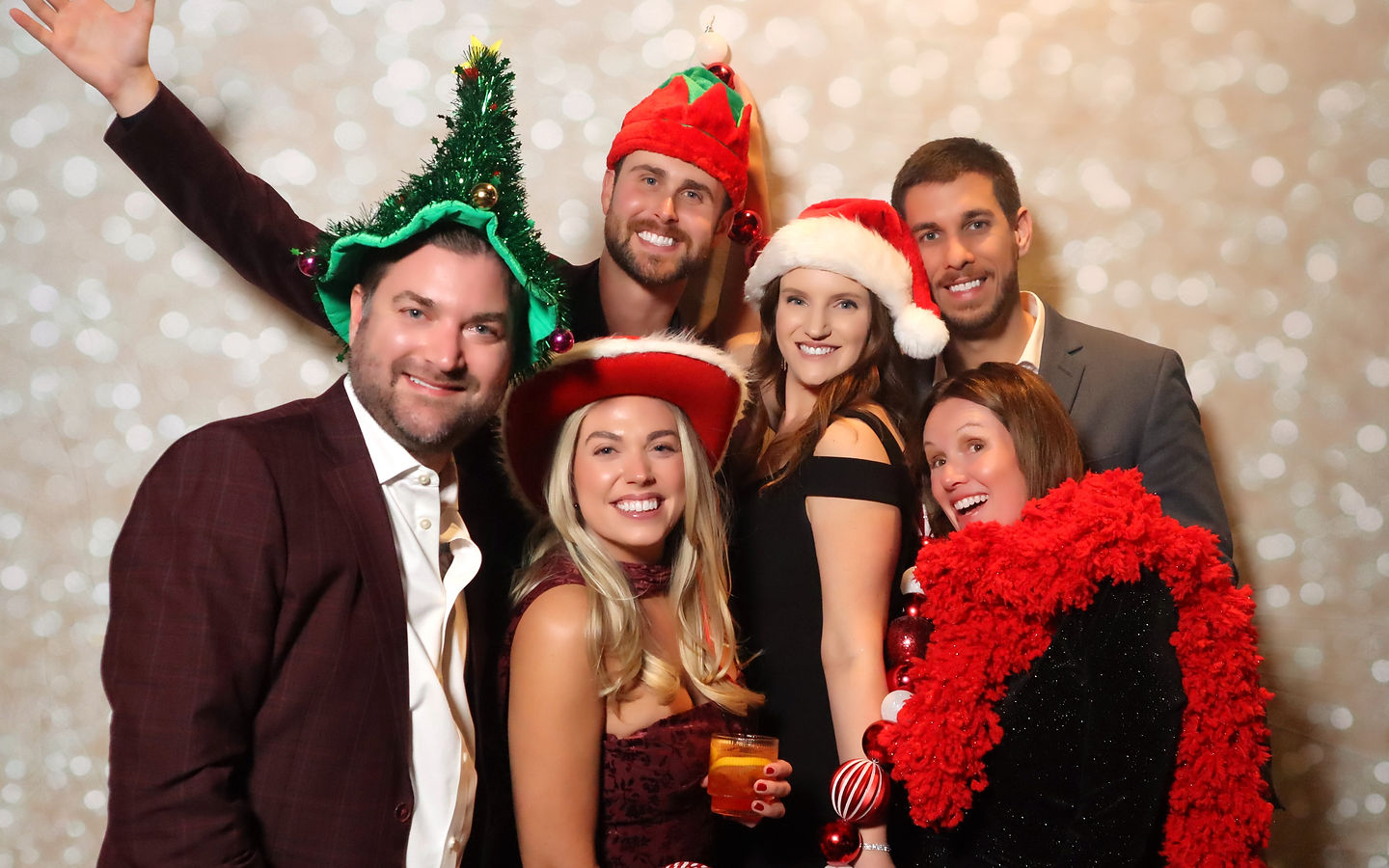 Holiday party guests in festive props at the photo booth