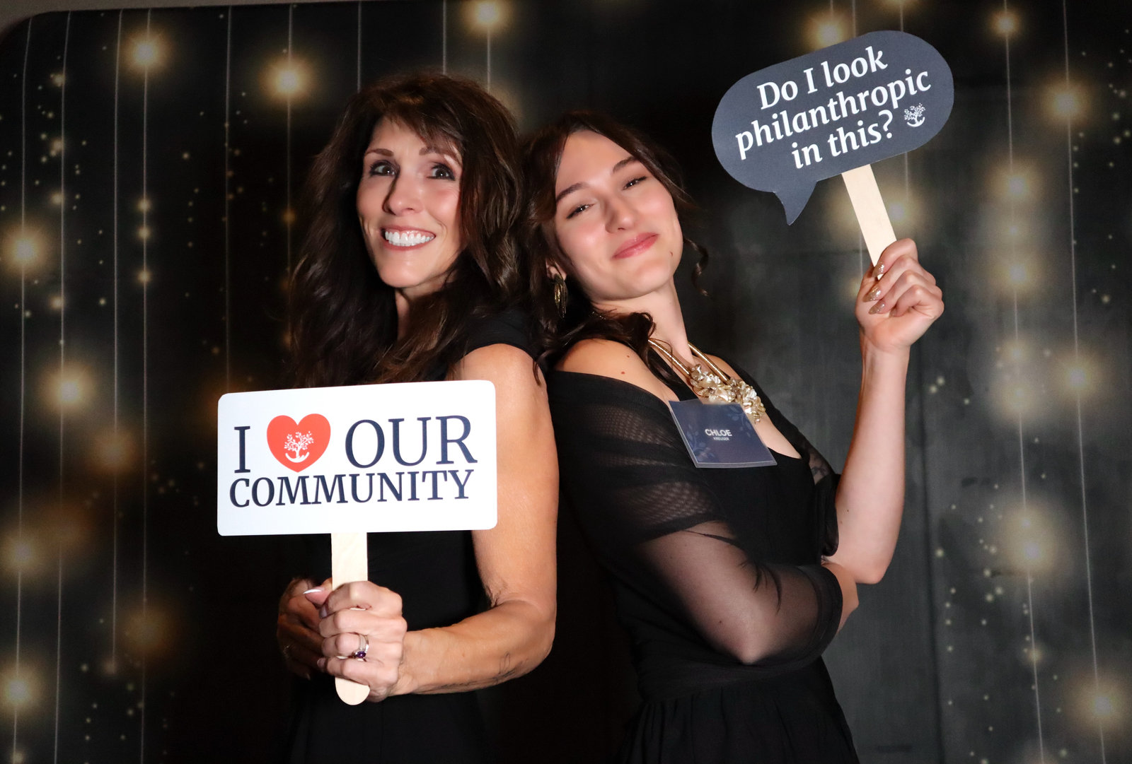Gala guests holding an I love our community sign