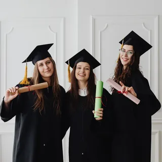 Graduates in caps and gowns at a school event photo booth