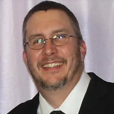 Jeff smiling in a suit