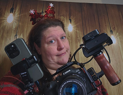 Jennifer McGreck with a camera rig, wearing a festive headband